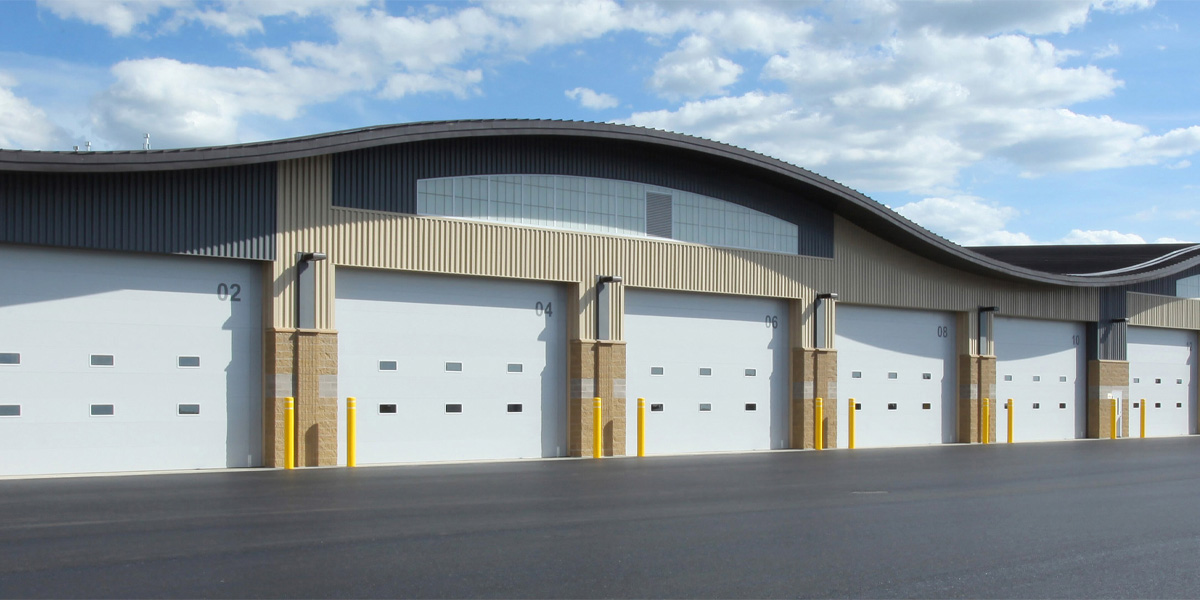 Several garage doors next to each other in a commercial building 